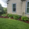 Red Rubber Mulch Garden Bed Next To House