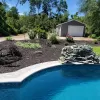 Brown rubber mulch in pool backdrop