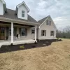 Front of house with brown rubber mulch garden beds