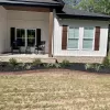 Front of house with black rubber mulch garden bed