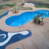 Pool with blue rubber mulch and white stone waves