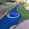 Pool landscaping with blue rubber mulch