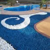Pool with blue rubber mulch landscaping