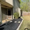 Front yard black rubber mulch garden bed