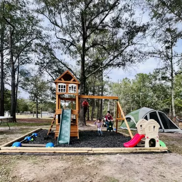 Playground with wood borders and uncoated rubber mulch
