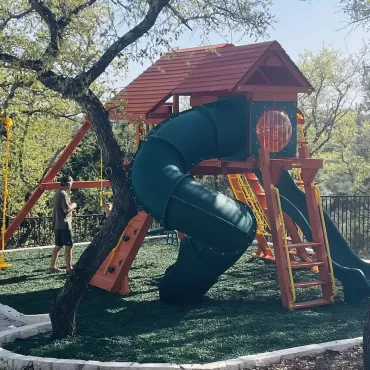 Playground with green rubber mulch surfacing