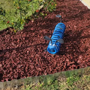 Red Rubber Mulch Landscaping with Blue Spring Sculpture