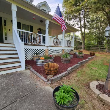 House with patio and red rubber mulch beds