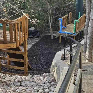 Brown rubber mulch and borders under a zip line