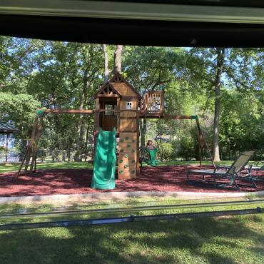 Grandkids playground with red rubber mulch