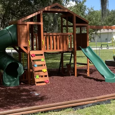 Red Rubber Mulch Playground in Backyard