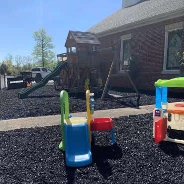 Church playground with black rubber mulch