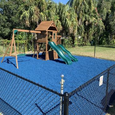 Playground with blue rubber mulch ground cover