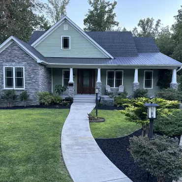 Beautiful house with black rubber mulch landscaping