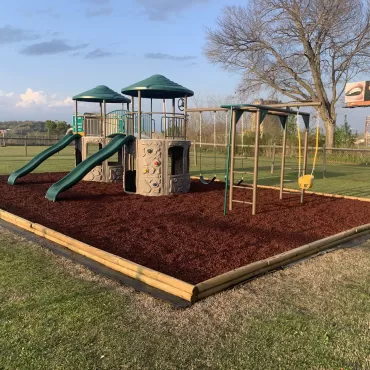 Church playground with red rubber mulch