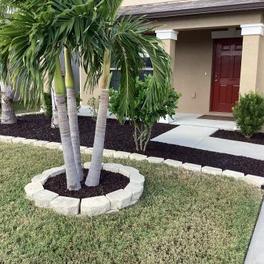 Brown Rubber Mulch Retained with White Rock Edging