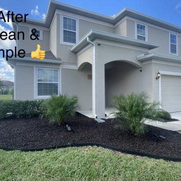 House with brown rubber mulch landscape bed in front