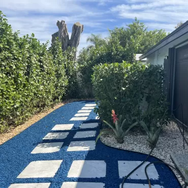 Stone paver path with blue rubber mulch fill