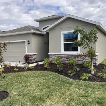 House with Brown Rubber Mulch Landscaping