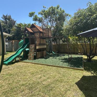 Playground surface with green rubber mulch