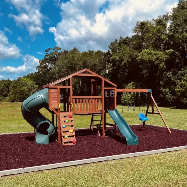 Playground with red rubber mulch ground cover