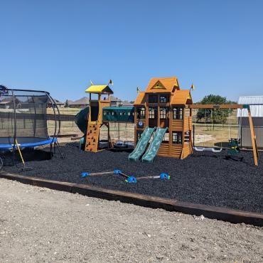 Play area covered with black rubber mulch Play area covered with black rubber mulch