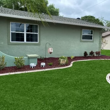 Landscaping with Red Rubber Mulch Beds Against the House
