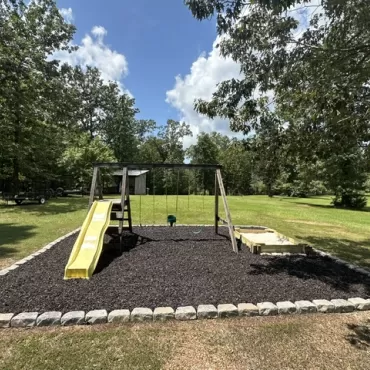 Brown Rubber Mulch Play Area with Stone Border