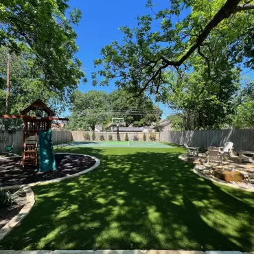 Yard with rubber mulch playground and basketball court and sitting area