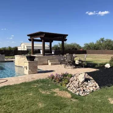 Pool that is using black rubber mulch for landscaping