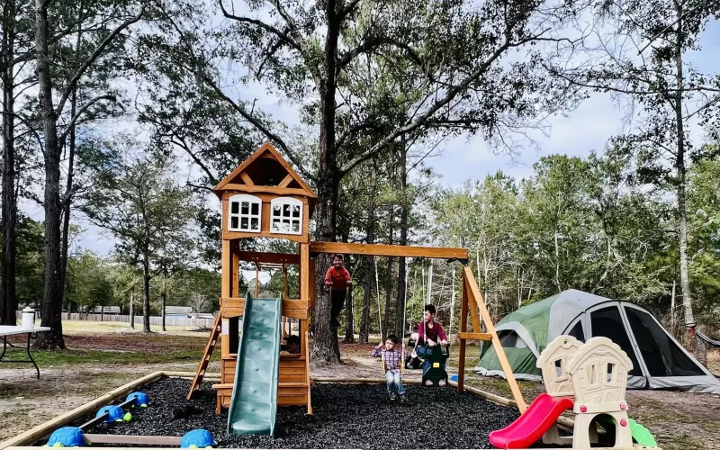 Playground with wood borders and uncoated rubber mulch