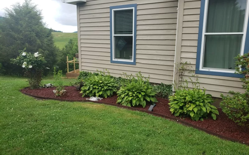 Red Rubber Mulch Garden Bed Next To House