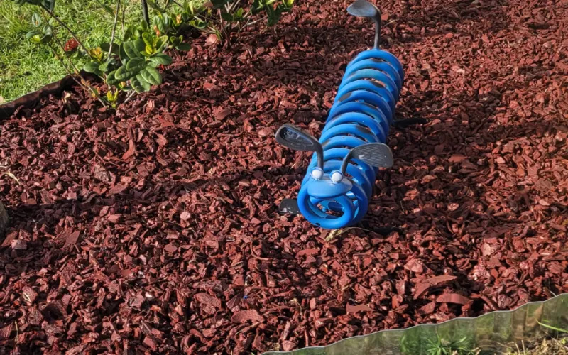 Red Rubber Mulch Landscaping with Blue Spring Sculpture