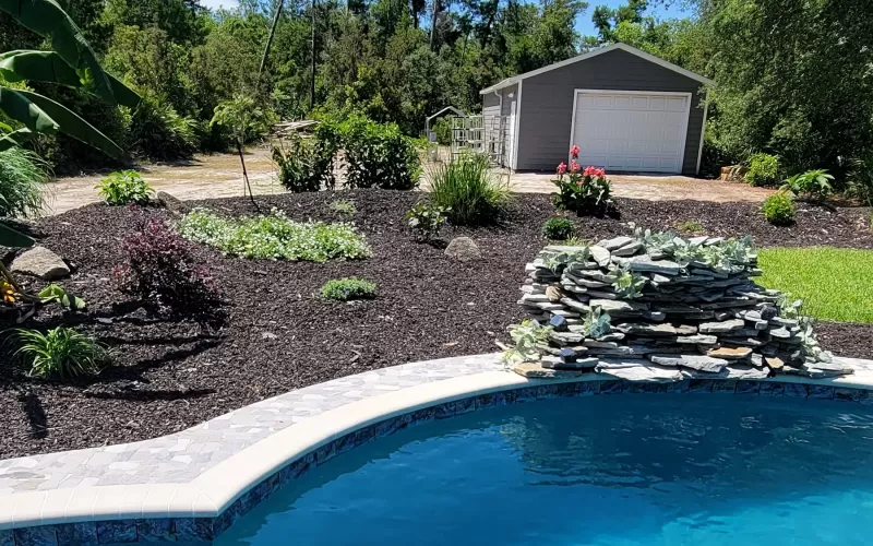 Brown rubber mulch in pool backdrop
