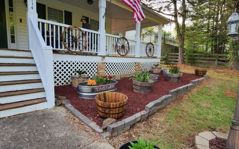 House with patio and red rubber mulch beds