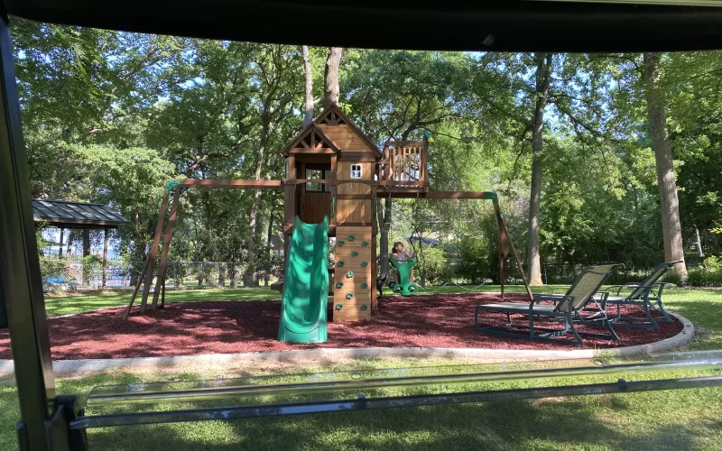 Grandkids playground with red rubber mulch