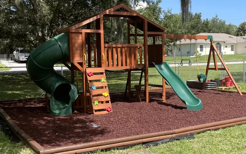 Red Rubber Mulch Playground in Backyard