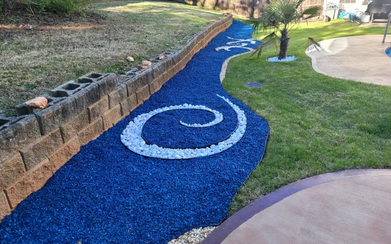 Pool landscaping with blue rubber mulch