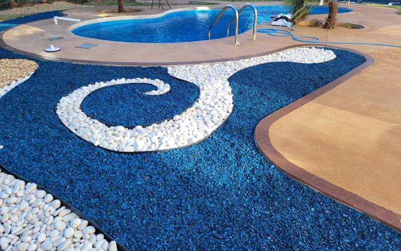 Pool with blue rubber mulch landscaping
