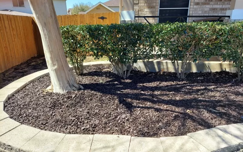 Brown Rubber Mulch Landscaping with Stone Edging