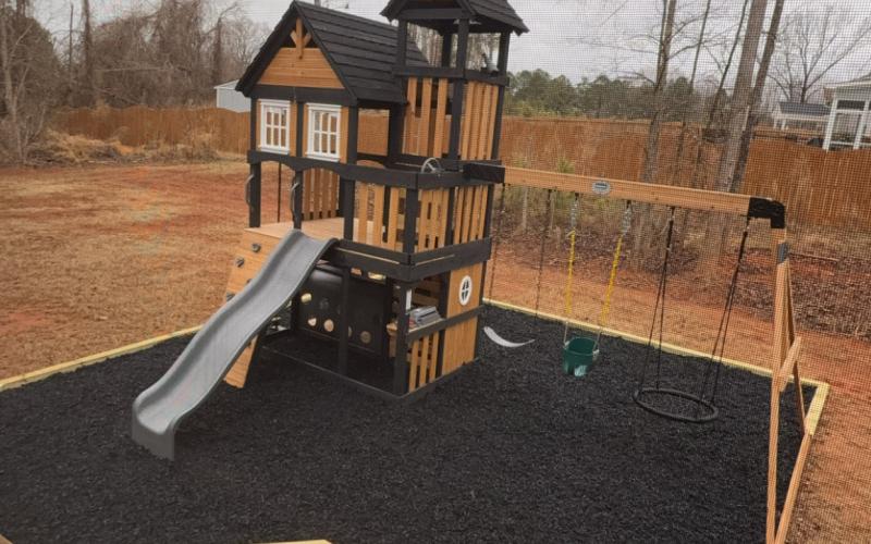Playground with black rubber mulch ground cover