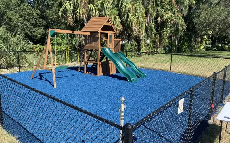 Playground with blue rubber mulch ground cover