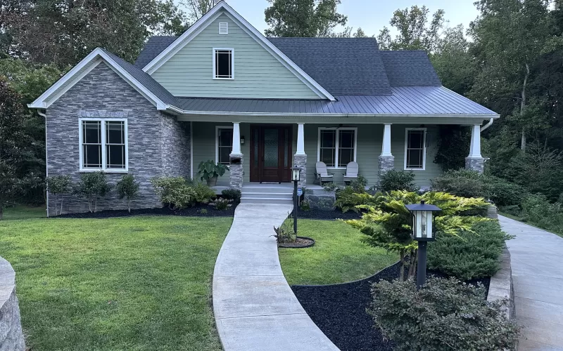 Beautiful house with black rubber mulch landscaping