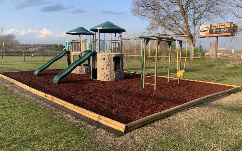 Church playground with red rubber mulch