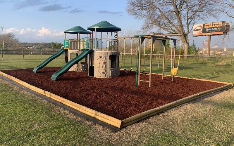 Church playground with red rubber mulch