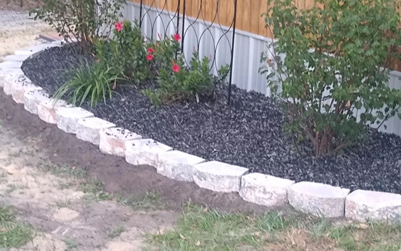 Uncoated rubber mulch landscaping around house
