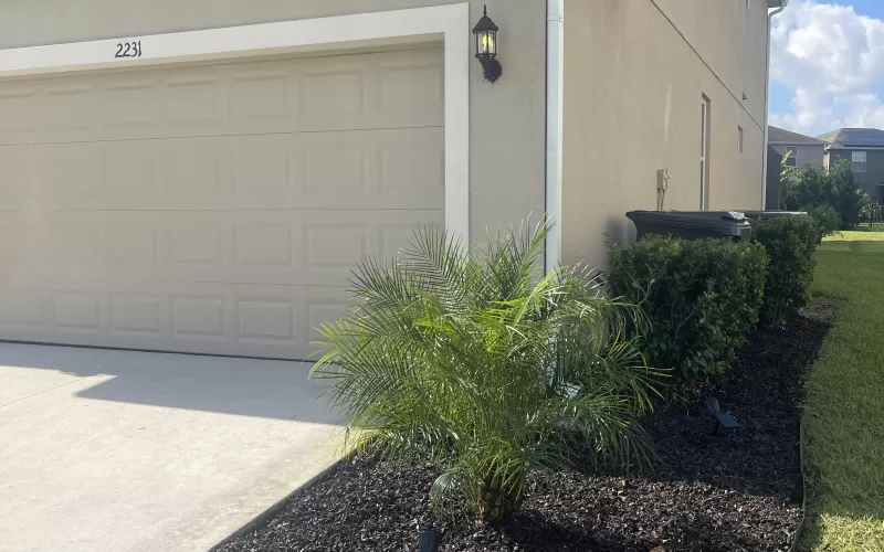 House with brown rubber mulch landscape beds