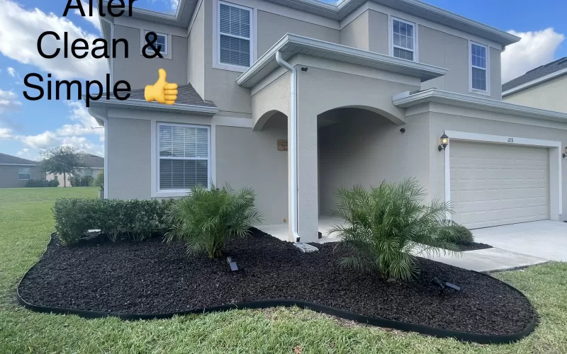House with brown rubber mulch landscape bed in front