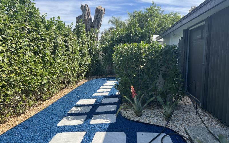 Stone paver path with blue rubber mulch fill