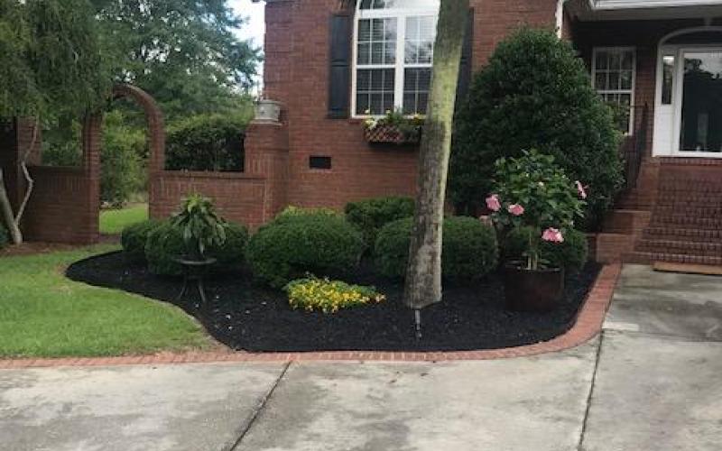 Black rubber mulch residential landscaping